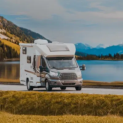 An RV with the background of a landscape.